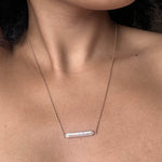 Maris pearl bar necklace on neck in gold color.